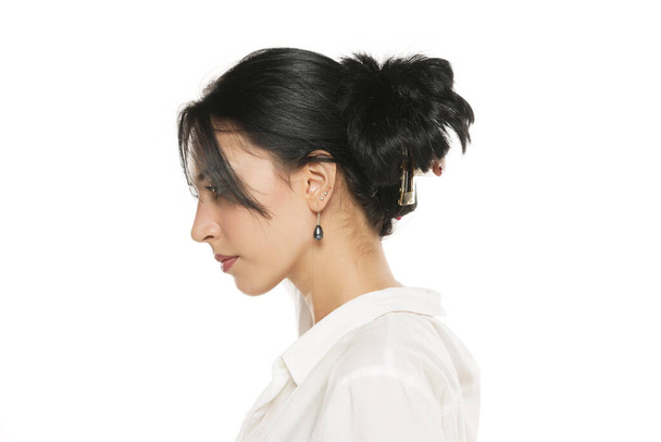 woman with hair clip on white studio background - Foto, Imagem