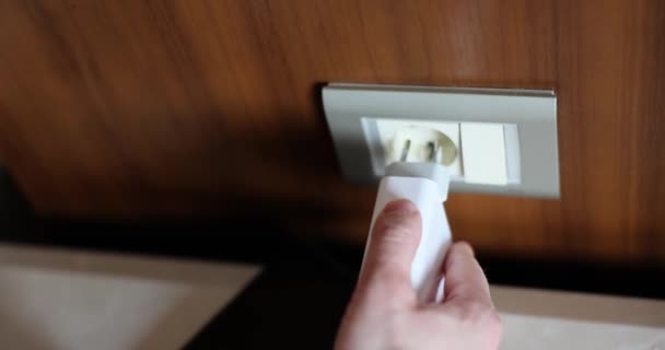 Closeup of man inserting plug into socket and charging smartphone. Phone charging - Video