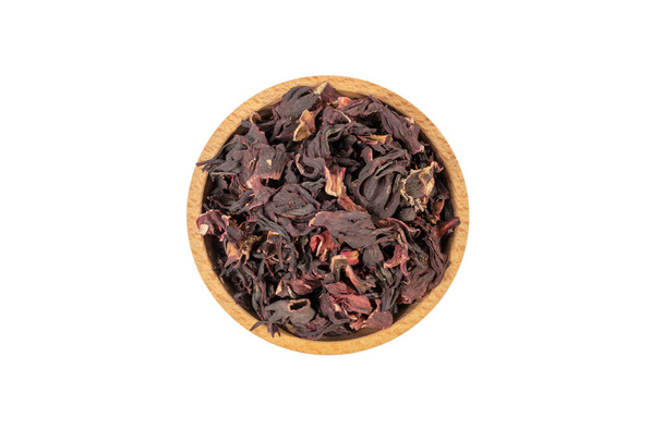 Dry hibiscus tea in wooden bowl isolated on white background. herb. herbal tea. food ingredient. - Foto, afbeelding