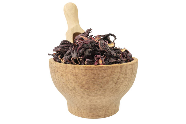 Dry hibiscus tea in wooden bowl and scoop isolated on white background.  herb. herbal tea. food ingredient. - Fotó, kép