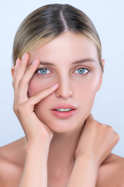 Alluring beautiful woman with perfect smooth and clean skin portrait in isolated background. Beauty hand gesture with expressive facial expression for skincare treatment product or spa. - 写真・画像