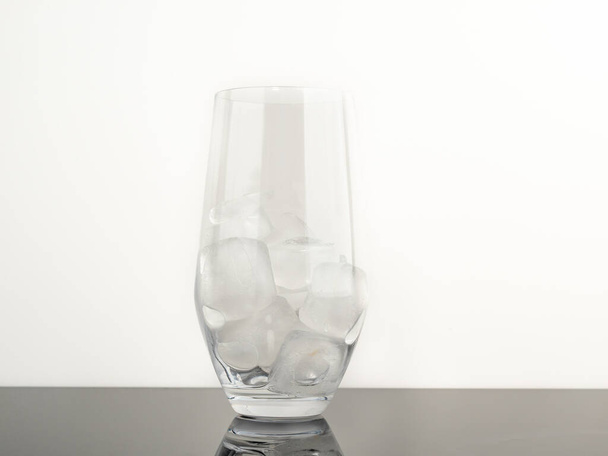 Glass with ice on a black background. Close-up. - Zdjęcie, obraz
