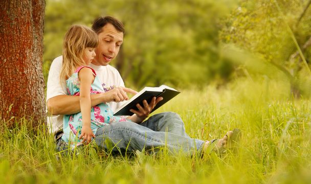 Father with little daughter reading - Photo, image