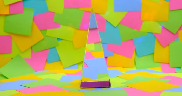 crystal pyramid spinning on Colorful sticky notes in background - Filmati, video