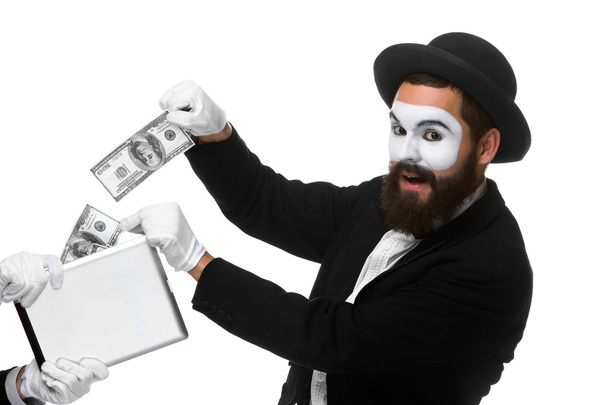 businessmans hand in the form of mime extract money from tablet PC - Photo, Image