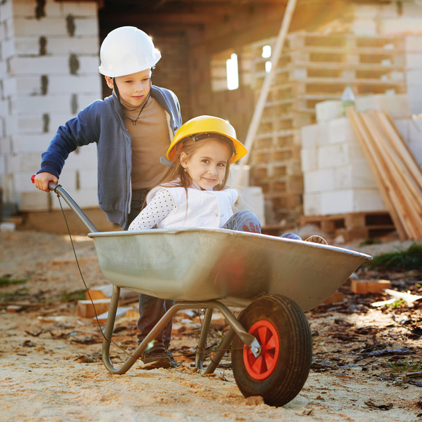 boy and girl playing on construction site - Фото, зображення