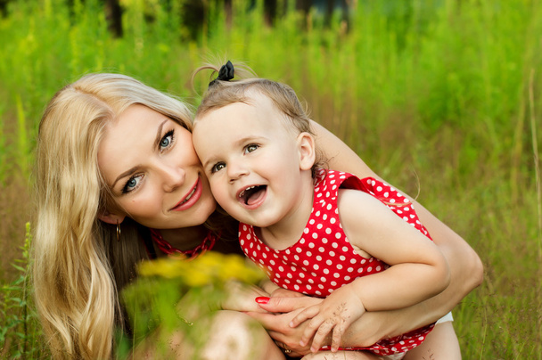 Portrait of mother with baby on nature background summer - Photo, Image