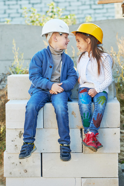 boy and girl playing on construction site - Foto, Imagen