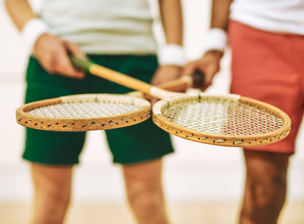 The kind of rackets pros use. two men crossing their racquets at a squash court - Photo, Image