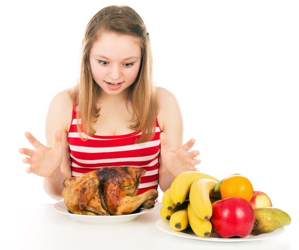 Beautiful girl happily looking at the chicken - Photo, Image