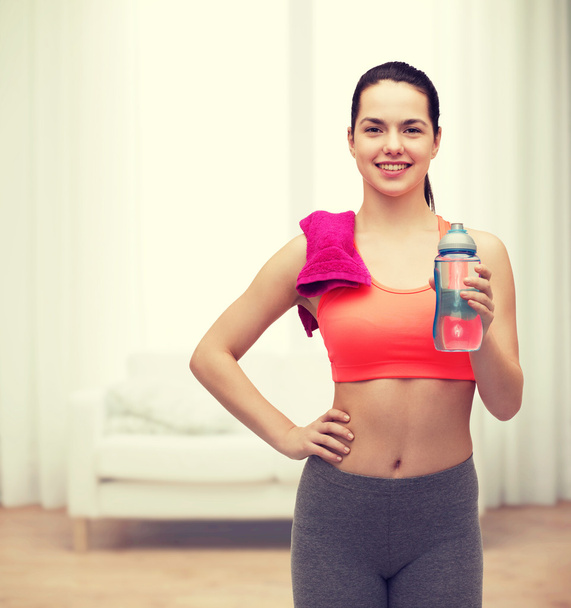sporty woman with towel and water bottle - Foto, immagini