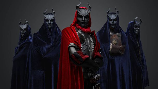 Portrait of four followers and their leader of dark cult dressed in dark robes. - Foto, afbeelding