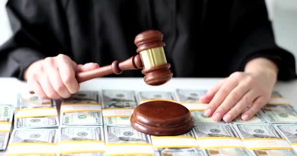Judge using gavel to pass judgment in courts. Dollars bill corruption and financial investment - Footage, Video