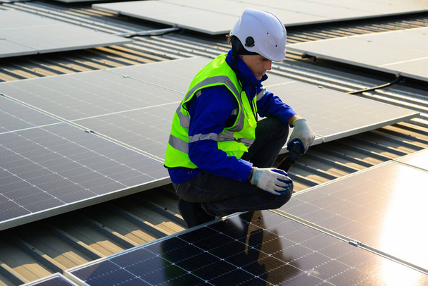 Professional technicians installing solar panels on rooftop of plant, Workers checking and operating system at solar cell farm power plant, Renewable energy source for electricity and power, Solar - Fotografie, Obrázek