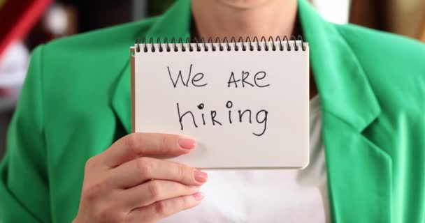Woman hand holding paper with inscription we are hiring. Finding job and successfully passing an interview - Filmmaterial, Video