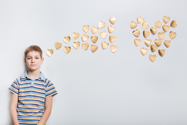 Boy thinking with golden hearts - Фото, изображение