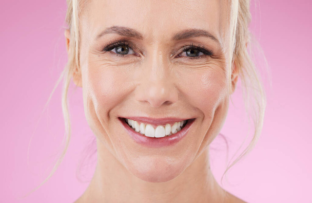 Dental, teeth and big smile, portrait of woman with glowing skin and natural spa makeup in studio. Mockup, facial and luxury skincare cosmetics, face of happy beauty model isolated on pink background. - Photo, Image