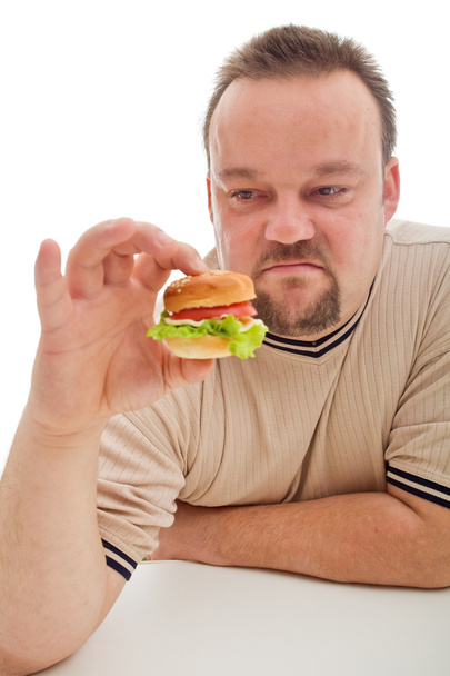 Мужчина недоволен размером своего гамбургера - крупный план
 - Фото, изображение