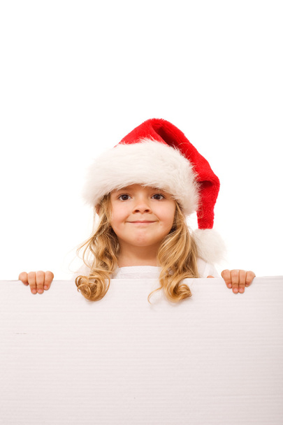 Little girl with santa hat and cardboard banner - Фото, зображення