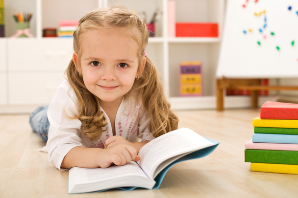 Happy little girl practicing reading - Photo, Image