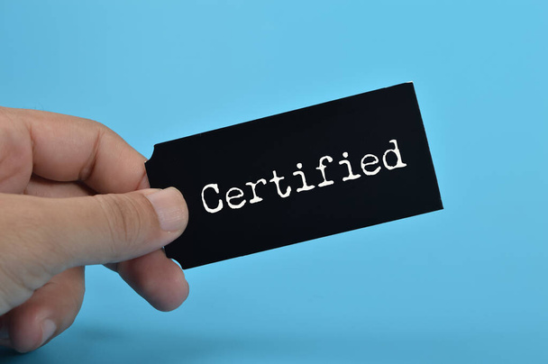 Black card written with CERTIFIED. Having a certified professional gives clients the assurance and confidence that they are working with someone who has undergone rigorous training - Photo, Image