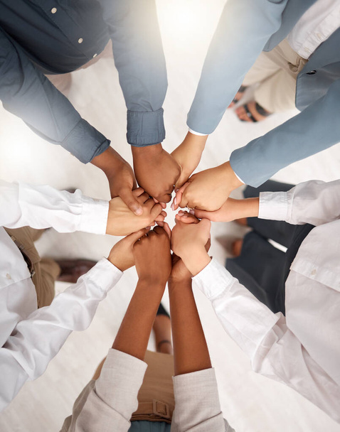Teamwork, diversity and group holding hands in circle for support, trust and team building together. Business people in huddle standing in solidarity at office workshop and commitment goal from above. - Fotó, kép