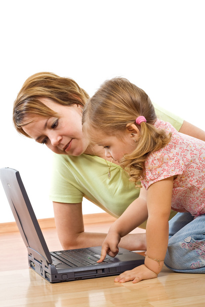 Woman and little girl with laptop - 写真・画像