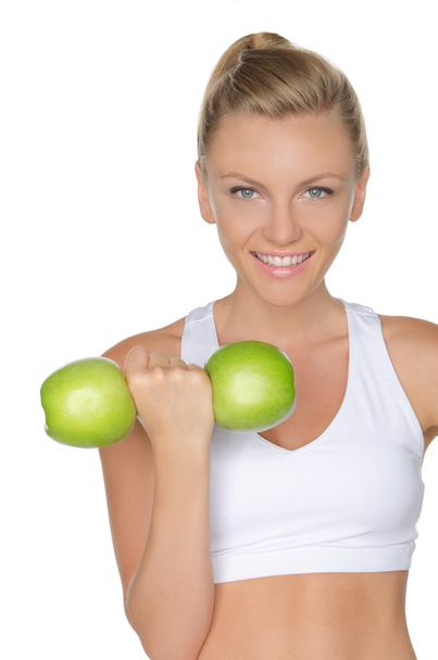 Woman with dumbbells of green apples  - Fotografie, Obrázek