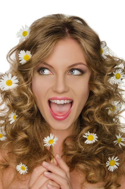 Smiling woman with daisies in hair looks away - Zdjęcie, obraz
