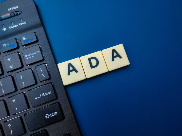 Toys word and keyboard with the word ADA on blue background. Business concept. - Foto, afbeelding