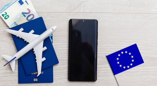 Flag of European Union with passport and toy airplane on wooden background. Flight travel concept. - Fotoğraf, Görsel