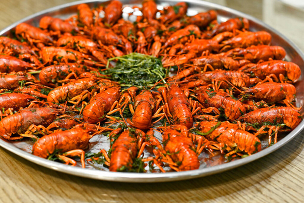 Boiled crayfish with spices in salt with foamy beer for a snack. - 写真・画像