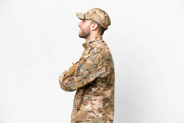 Military man over isolated white background in lateral position - Photo, Image