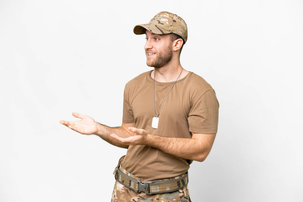 Military with dog tag over isolated white background with surprise facial expression - Photo, Image