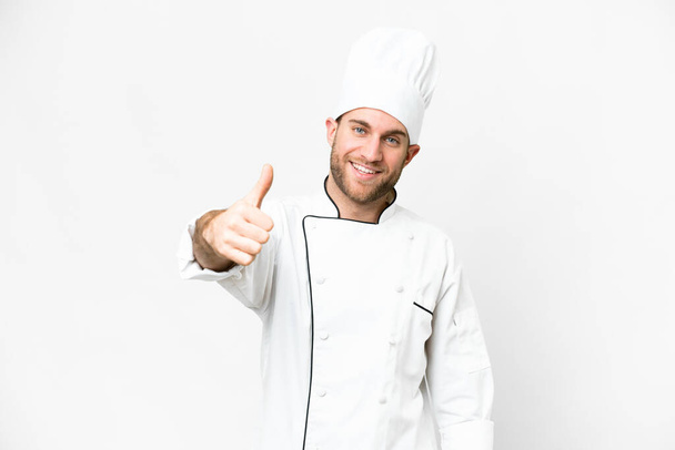 Молодий блондинка шеф-кухар над ізольованим білим тлом з великими пальцями вгору, тому що сталося щось хороше
 - Фото, зображення