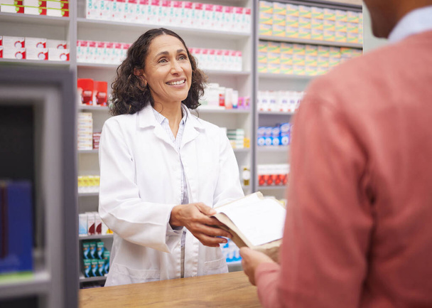 Medicine, pharmacy and doctor with patient in store with mockup prescription package for healthcare. Pharmacist woman giving man pills, box or Pharma product for medical help, health and wellness. - 写真・画像