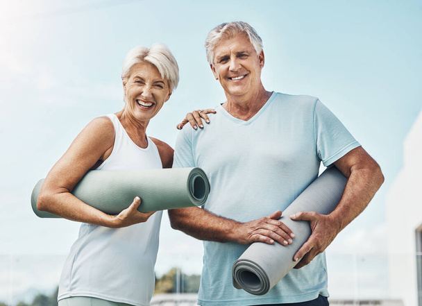 Senior couple, yoga and smile with mat in preparation for healthy spiritual wellness in nature. Portrait of happy elderly woman and man getting ready for calm or peaceful meditating exercise outdoors. - Photo, image
