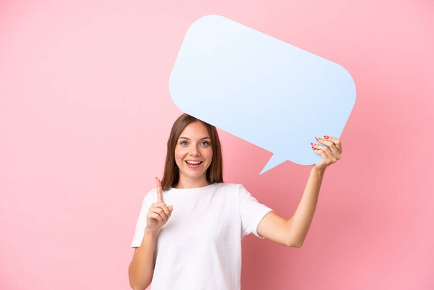 Young Lithuanian woman isolated on pink background holding an empty speech bubble with surprised expression - Valokuva, kuva