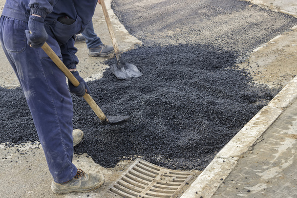 Asphalt workers with shovels patching asphalt 2 - Photo, Image