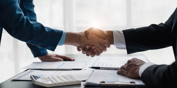 Business handshake for teamwork of business merger and acquisition,successful negotiate,hand shake,two businessman shake hand with partner to celebration partnership and business deal concept... - Photo, Image