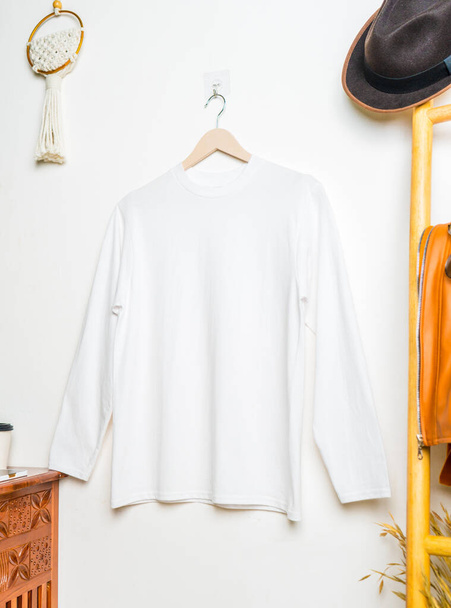 The shirt mockup highlights a long-sleeved top that boasts a simplistic yet refined design - Photo, Image