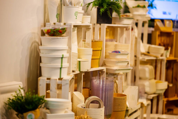 Wooden Stand With Different Plastic And Paper Disposable Boxes For Takeaway Or Delivery. Small Depth Of Field. High quality photo - Foto, imagen