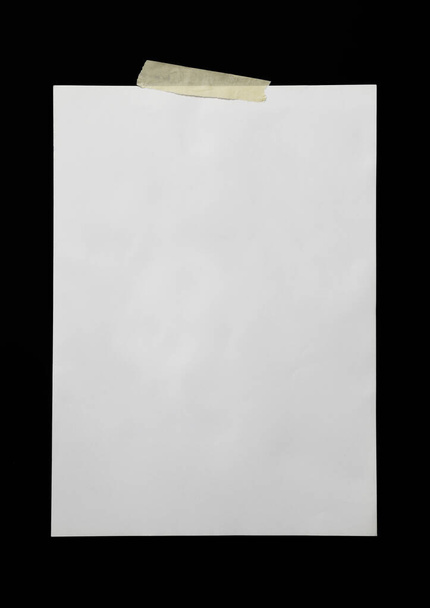 A blank sheet of A4 paper on black background - Foto, Imagen