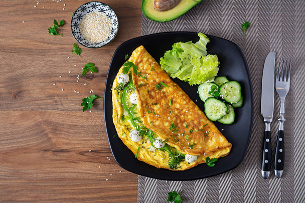 Omelette with mozzarella cheese and avocado. Ketogenic, keto diet breakfast. Top view, copy space - Foto, afbeelding