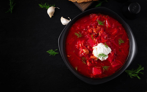 Traditional Ukrainian borscht. Bowl of red beetroot soup borsch with white cream. Beet root delicious soup. Ukrainian food. Top view, overhead - Foto, immagini