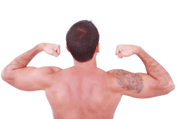 mladá sexy muž ukazuje jeho biceps izolované na bílém - Fotografie, Obrázek