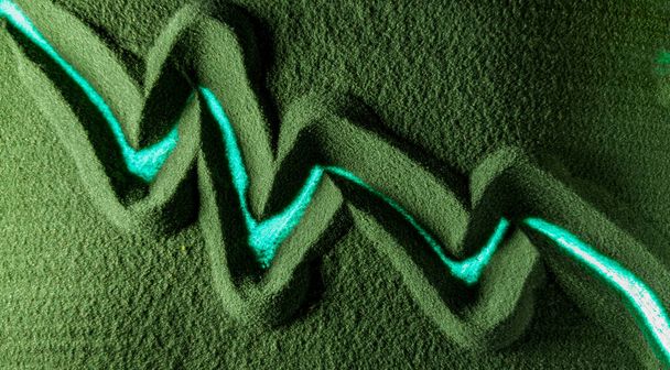 Hand drawing the growth chart, bear market, dump in the Green Sand. Male hand writes the growth chart, bull market symbol on the green sand with backlight. Top view 4k resolution - Fotó, kép