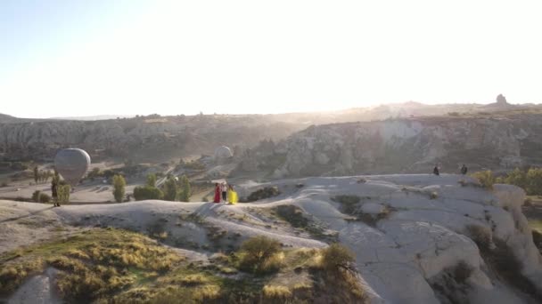 Drone footage of Girls in different dress in Cappadocia with champagne, Sunset view, Drone footage . High quality FullHD footage - Materiał filmowy, wideo