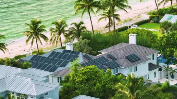 New residential house on USA seashore with roof covered with solar panels for producing clean ecological electricity in suburban rural area. Concept of investing in autonomous home for energy saving. - Video