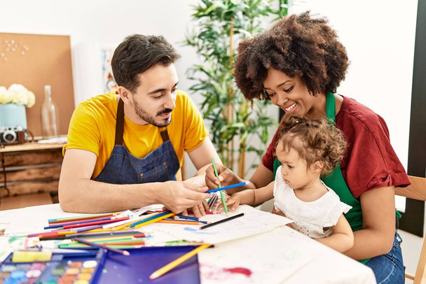 Couple and daughter smiling confident drawing at art studio - Photo, Image
